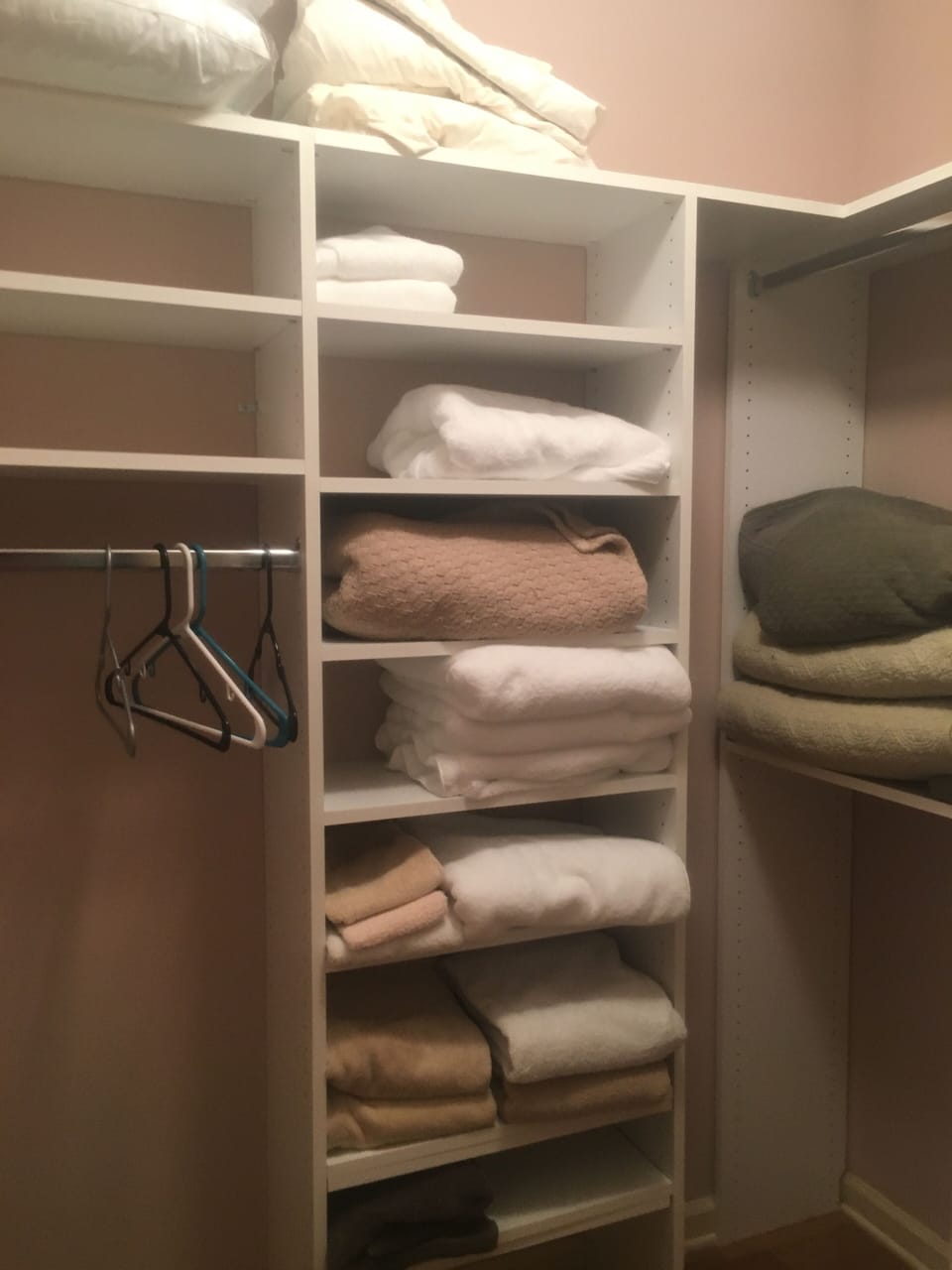 Primary Closet Shelving - Primary closet with shelves, hanging space, extra linens, and storage.