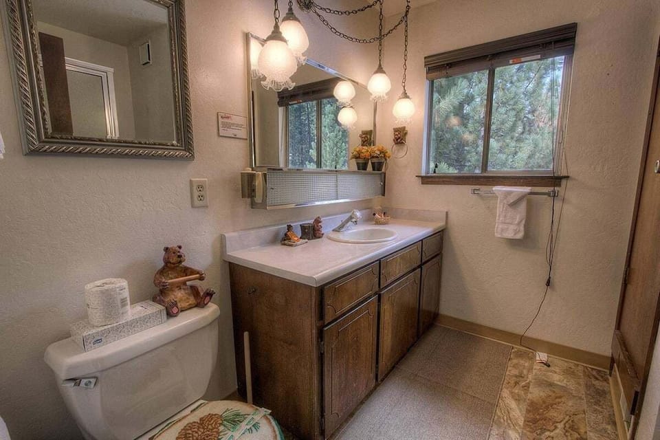 Bathroom with a long single vanity and a window.