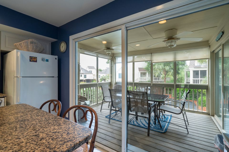 Sliding doors off the kitchen lead out to the screen porch