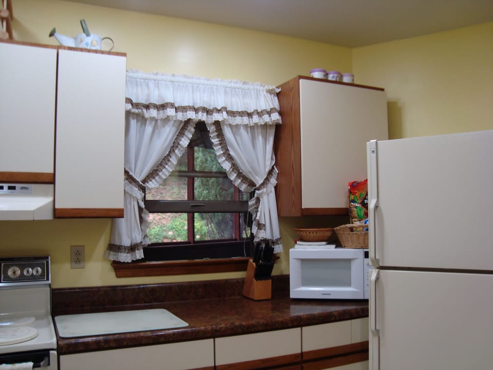 Galley kitchen with all dishes, all utensils, all cookware, & all appliances.