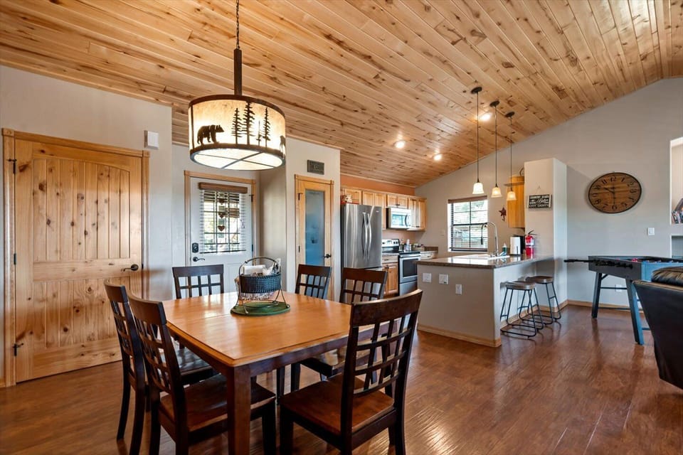 Open, updated kitchen and dining area. Custom lamp with an outdoor motif. 