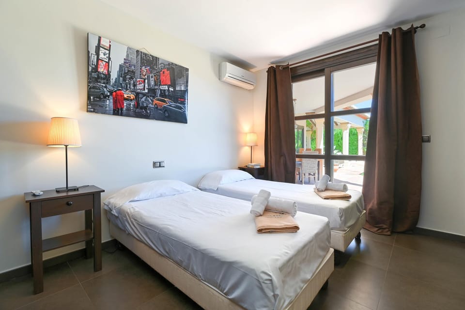 Bedroom with patio doors to the terrace and/or swimming pool