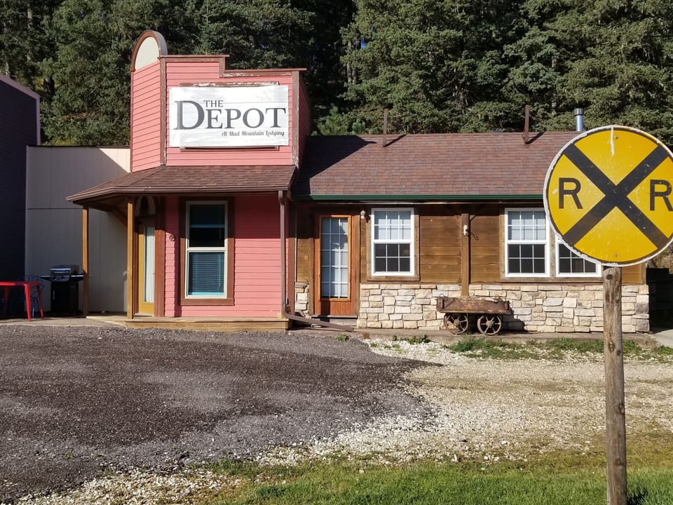 the front access door is to the left, under the porch.

