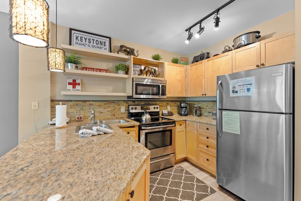 Your fully equipped kitchen awaits with granite counters, stainless appliances, and stylish pendant lighting for memorable meal prep.
