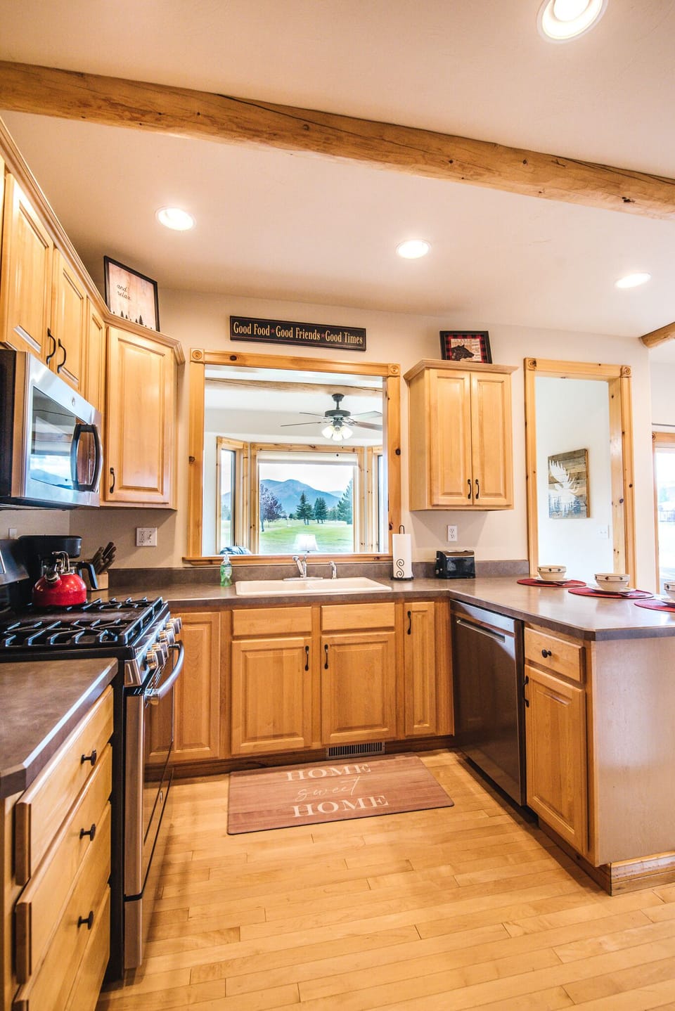 Kitchen with modern appliances and fully stocked for cooking and serving meals.