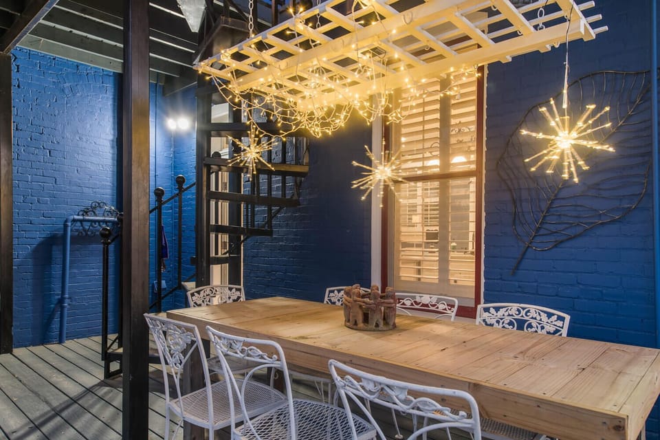 1st floor balcony with dining table and stairway to second floor balcony