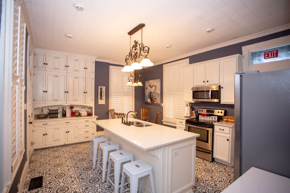 Kitchen with bar that seats 4 and dining table that seat 4