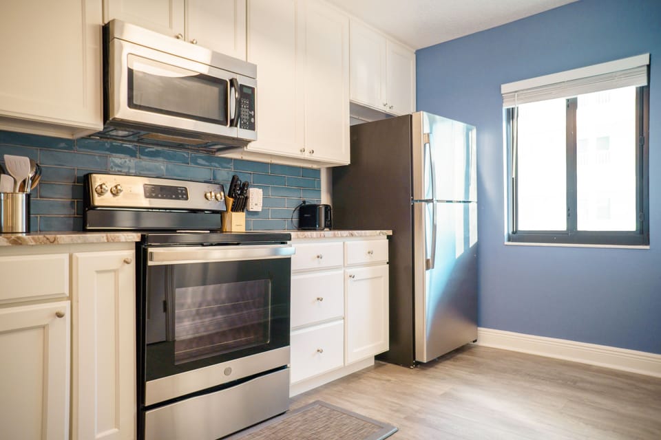 Newly renovated kitchen - stocked with dishware, glassware and cookware