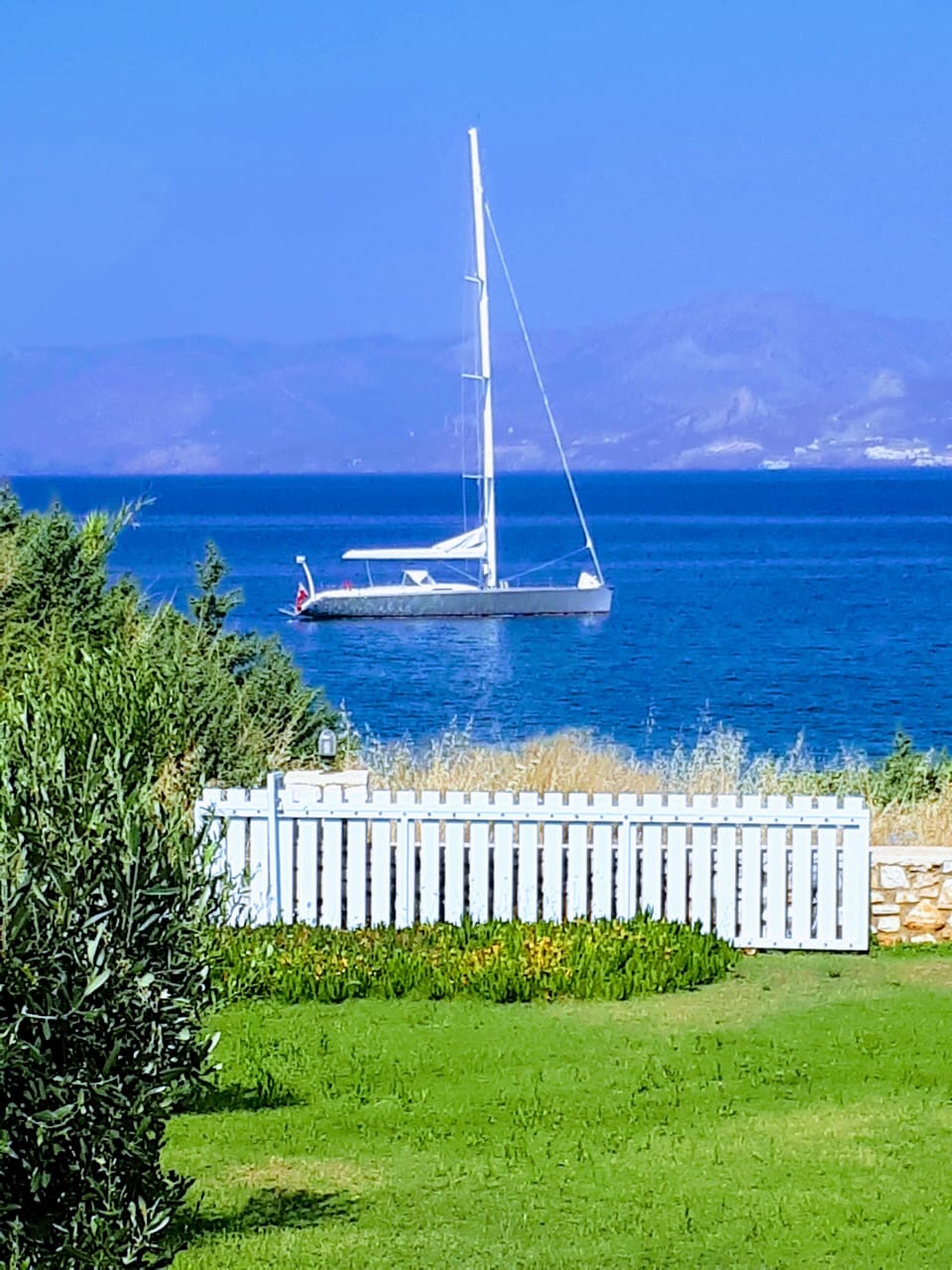 Sail boat in front of villa
