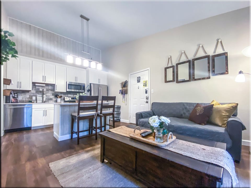 Wide angle view of open concept kitchen and living space - high vaulted ceiling.