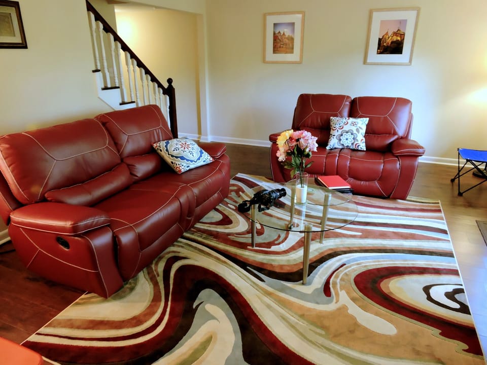Living Room with  trendy reclining sofa and love seat, glass coffee table