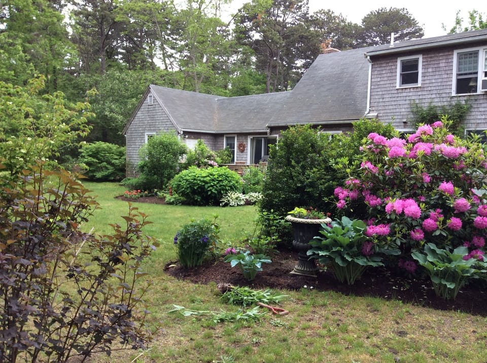 Beautifully landscaped gardens with deck barbecue grill and fire pit