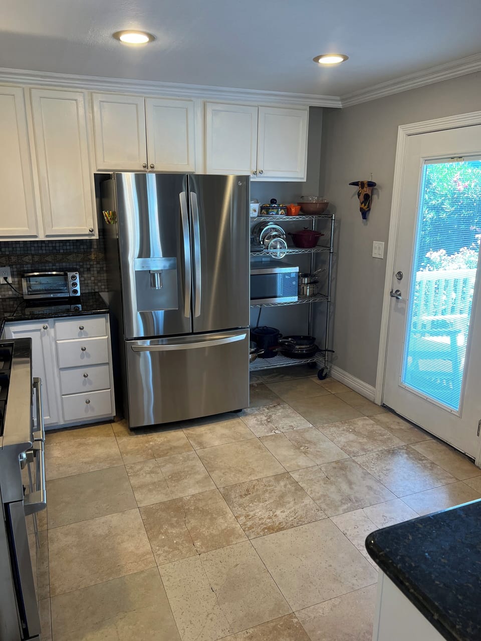 Door leads to side balcony and outdoor dining table.