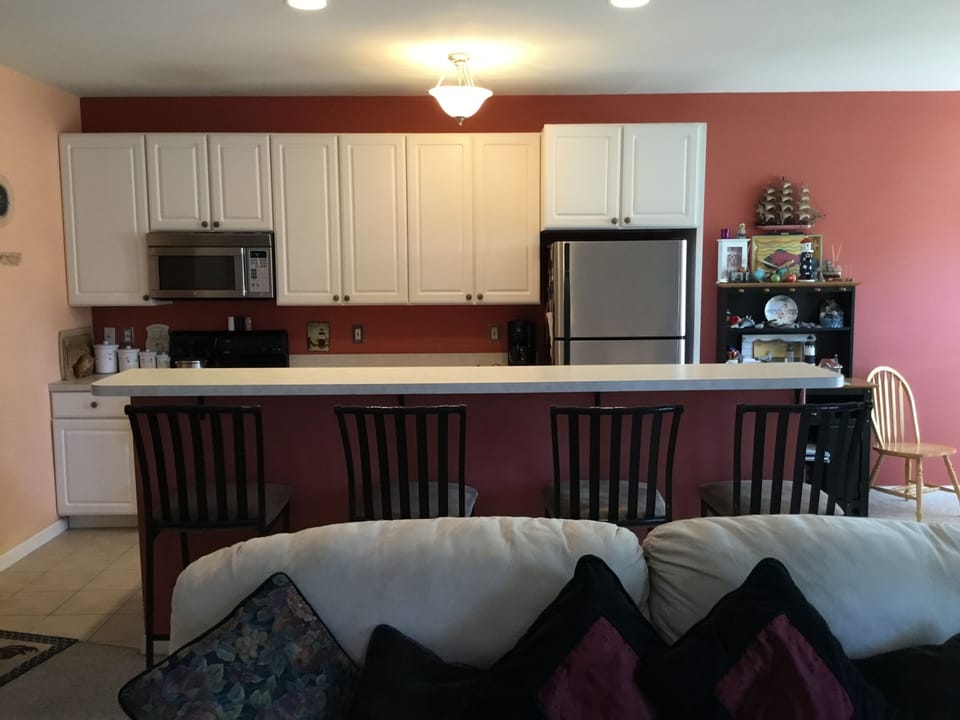 Full kitchen with high top bar.