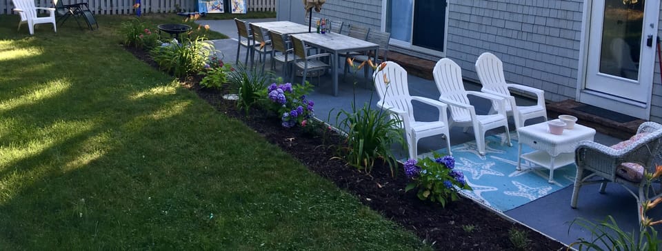 35' Long Rear Patio with teak, Adirondacks ad flower boxes.