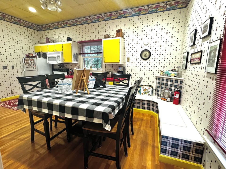 Dining table in kitchen with 6 stools. 