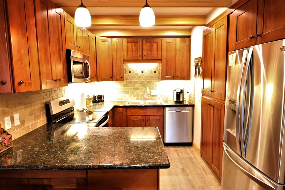 Kitchen with Keurig and Mr Coffee machines.  Blender is in cabinet.
