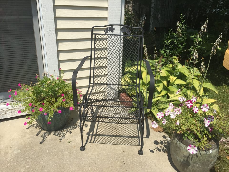 Front porch chair does a gentle rocking for your front porch enjoyment.