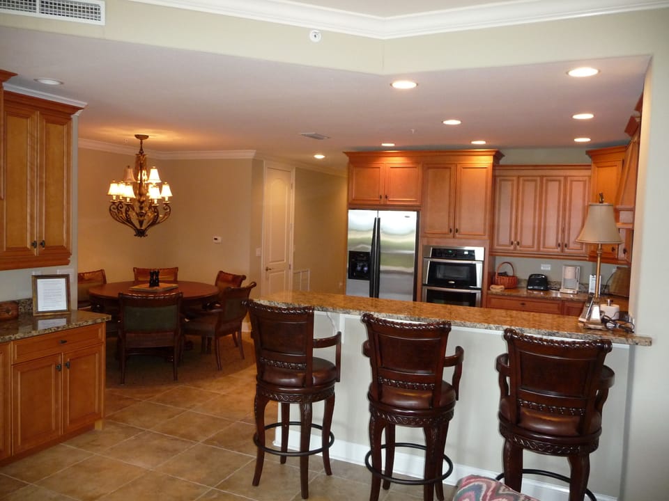 View of kitchen, dining room, breakfast bar, and wine cabinet