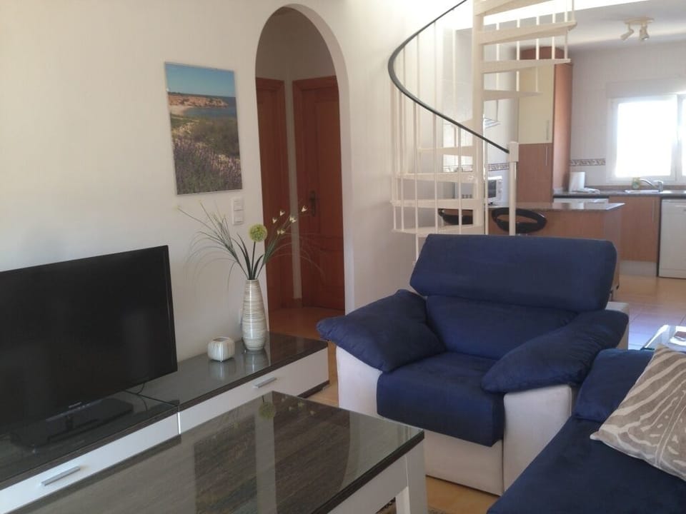 An open plan design living area, stairs to the upper floor