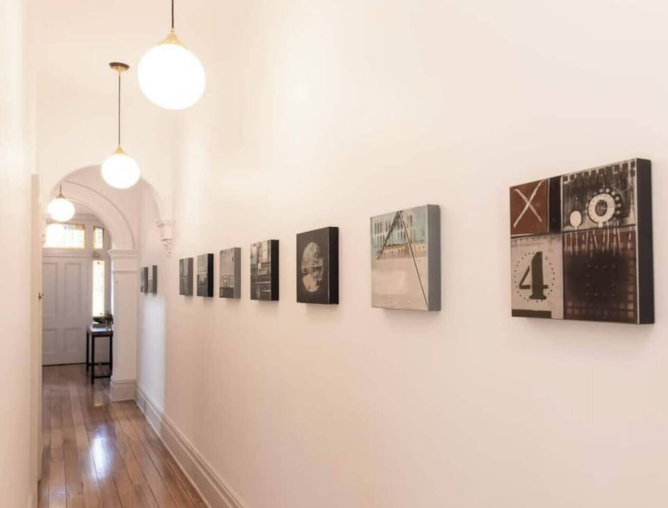 The long hallway is adorned with beautiful frames, adding to the home's charm and character. These artistic touches enhance the welcoming and stylish atmosphere of Victoria’s Terrace.