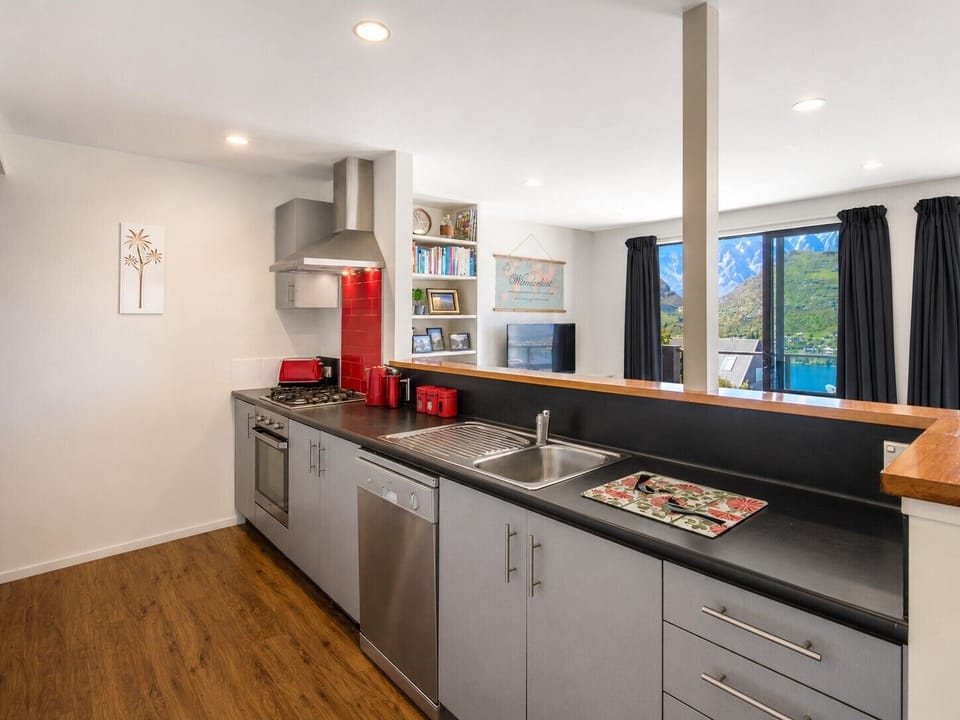 Fully equipped kitchen with oven, gas hob, dishwasher and microwave.