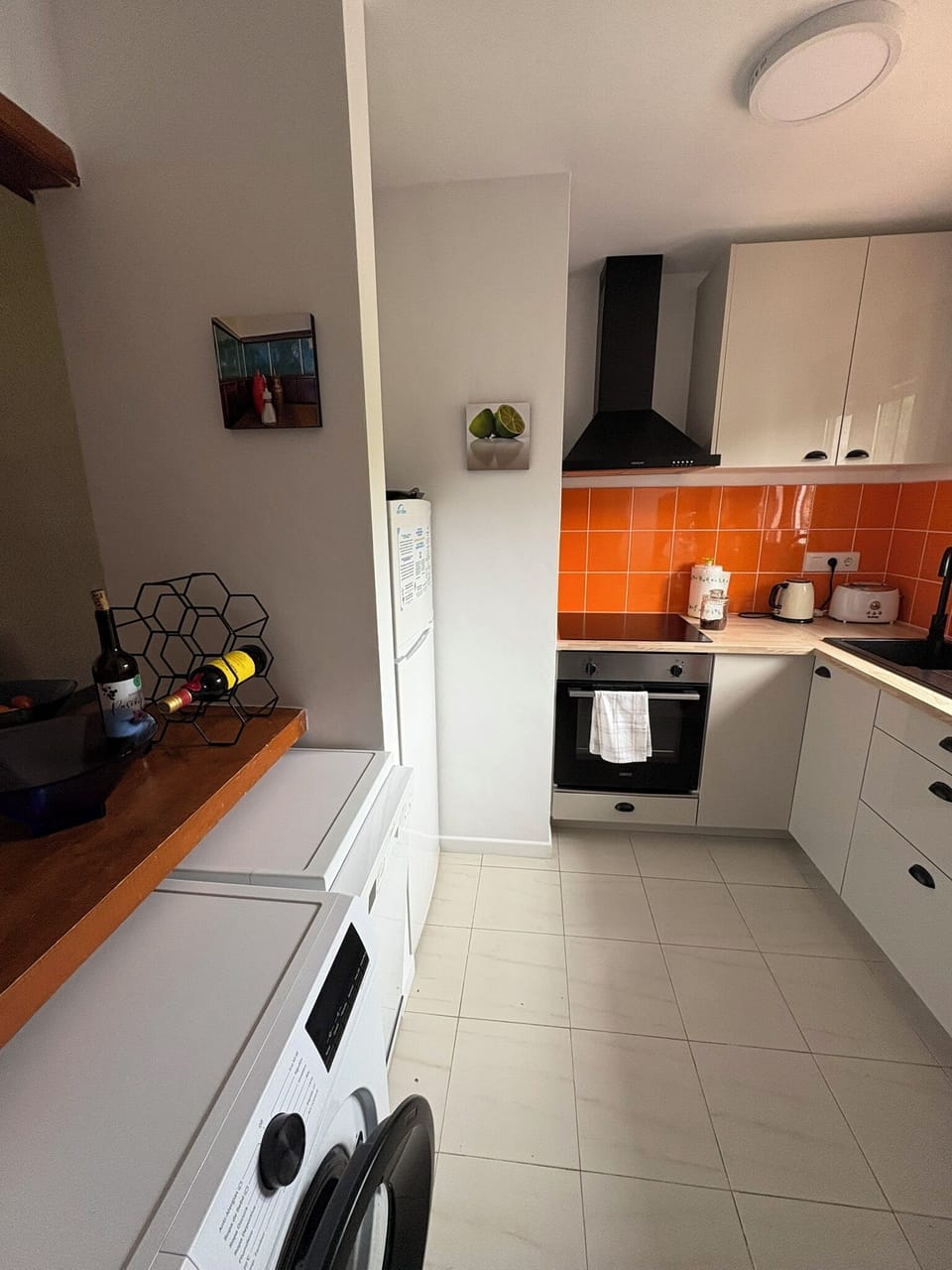 Kitchen with washing machine, dishwasher and electric oven and hob