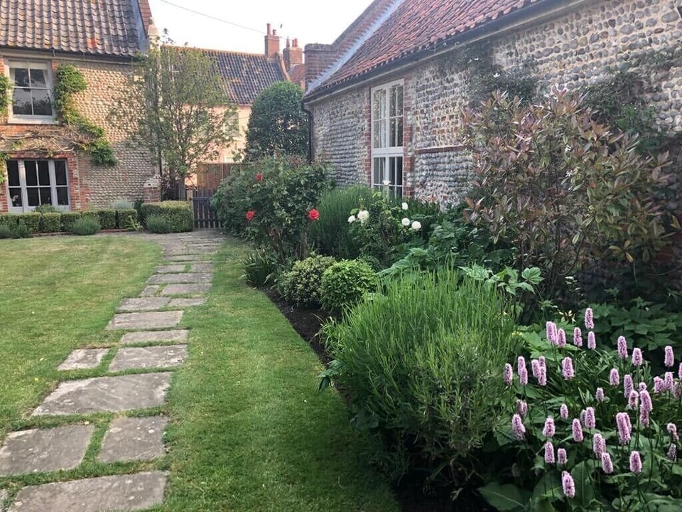 Exterior of barn, with windows looking out onto the pretty garden of Manor House