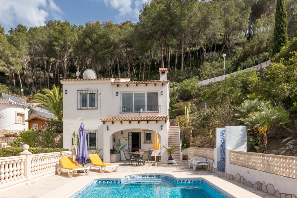 View from the end of the pool towards the villa, outside shower to the right
