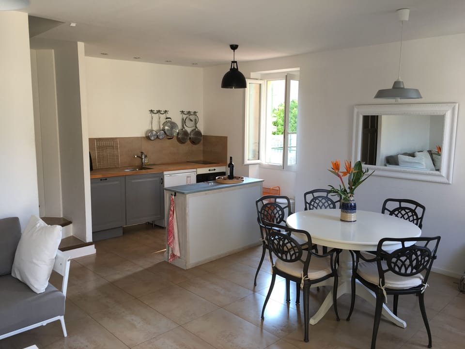 Open plan kitchen with induction hob, oven and dishwasher.