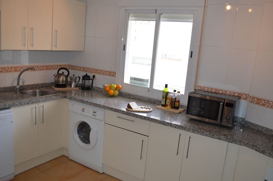 Corner of the large kitchen (inc breakfast bar) which has the facilities of home