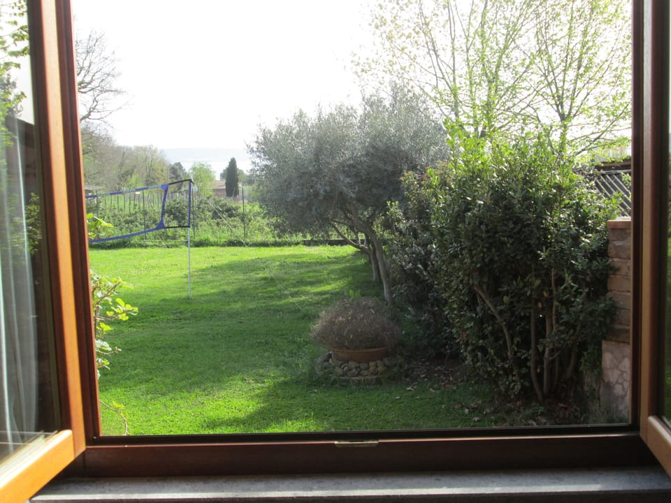 Bedroom with garden and lake view