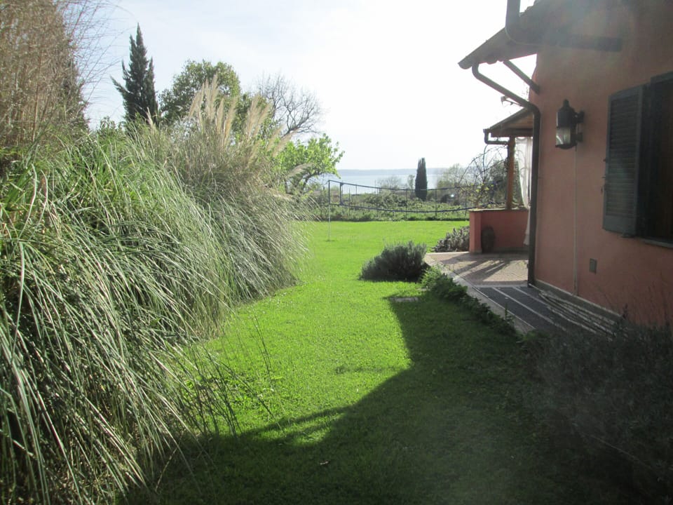 Side of the house with lake and garden views