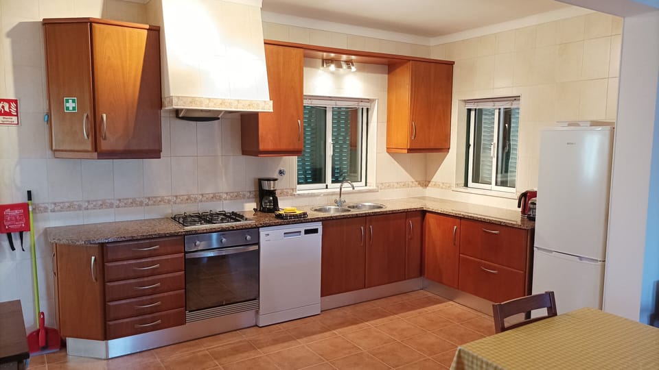 kitchen with hob, oven, dishwasher, fridge/freezer, kettle and toaster 
