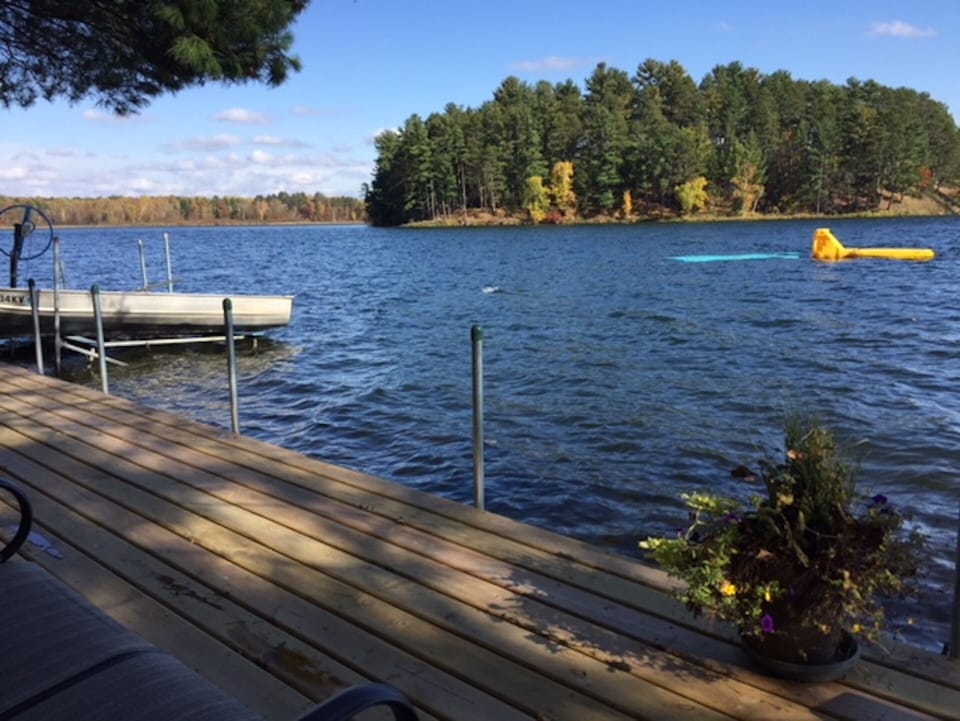 Waterfront with diving raft, dock, and water mat.