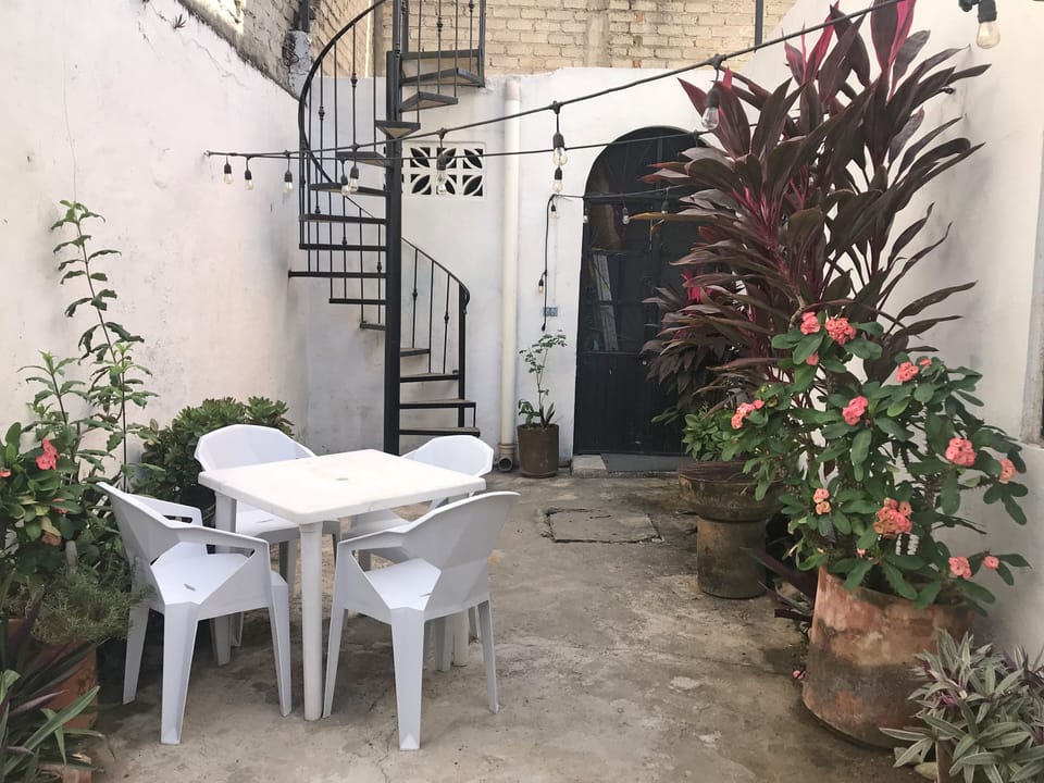 Patio with spiral stair access to shaded rooftop. Note spiral stairs are narrow.