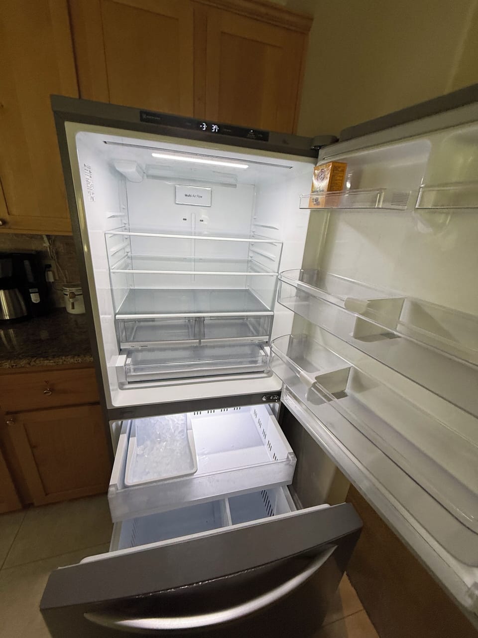 Full size refrigerator in the kitchen and another in the garage.