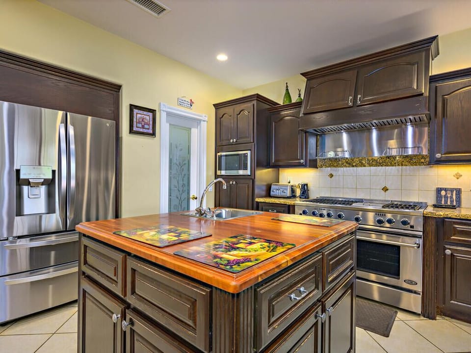 Chef's Open-Kitchen features a large central island & promotes communal living.