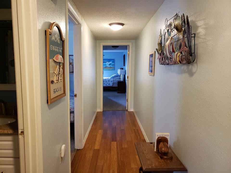 This hall separates the living areas and the bedrooms/bathrooms