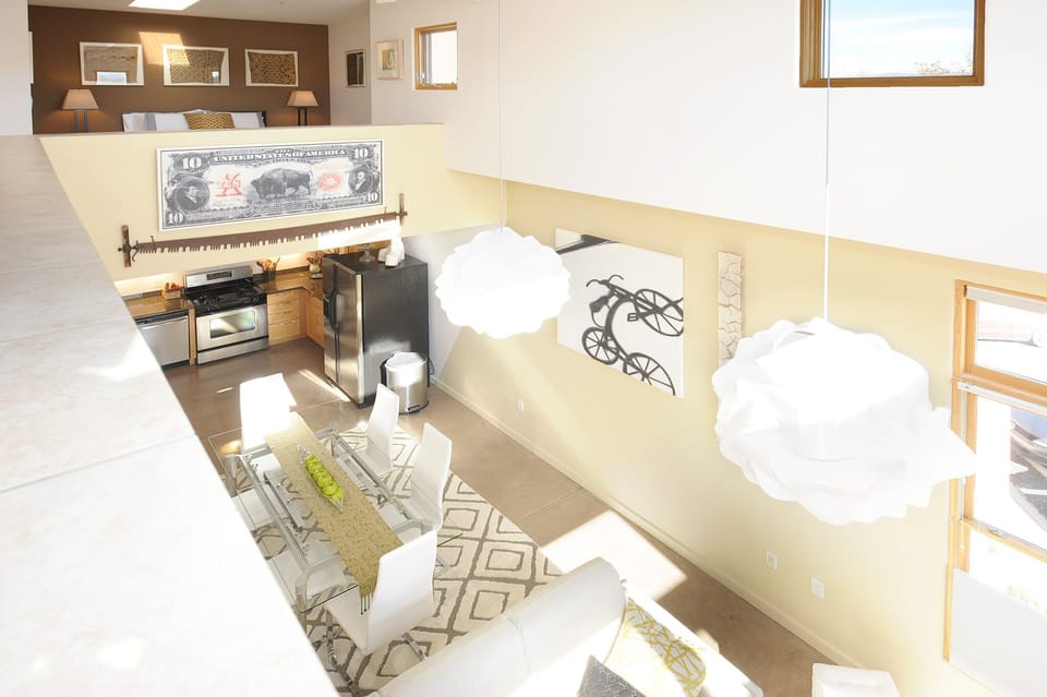 view from the sleeping loft to the dining/kitchen area on main living level