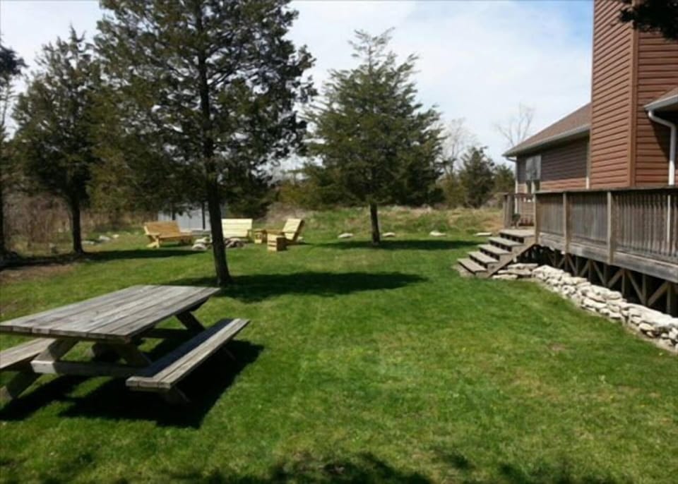 Large side yard for outdoor activities including a picnic table that seats 8