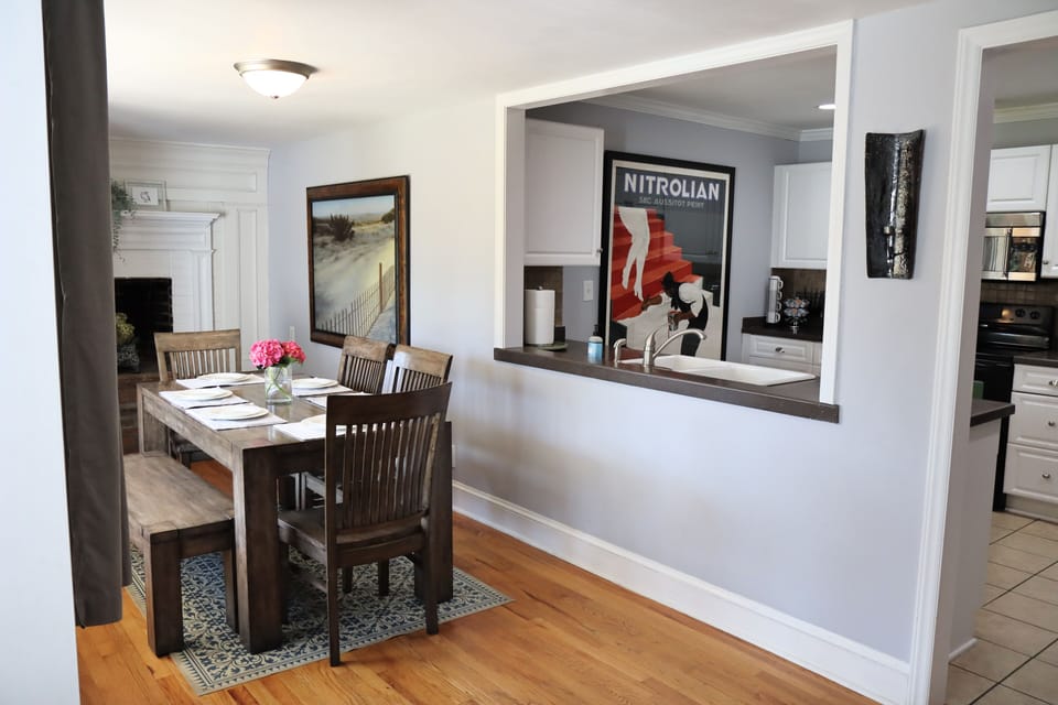 Kitchen open to dining room table seats 6.