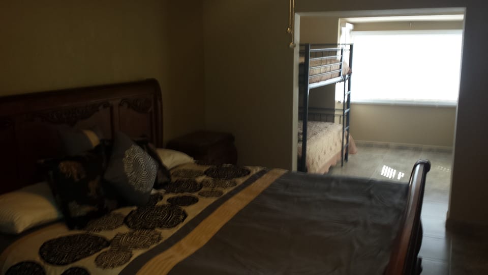 master bedroom w/king bed, bunk beds and private bath.