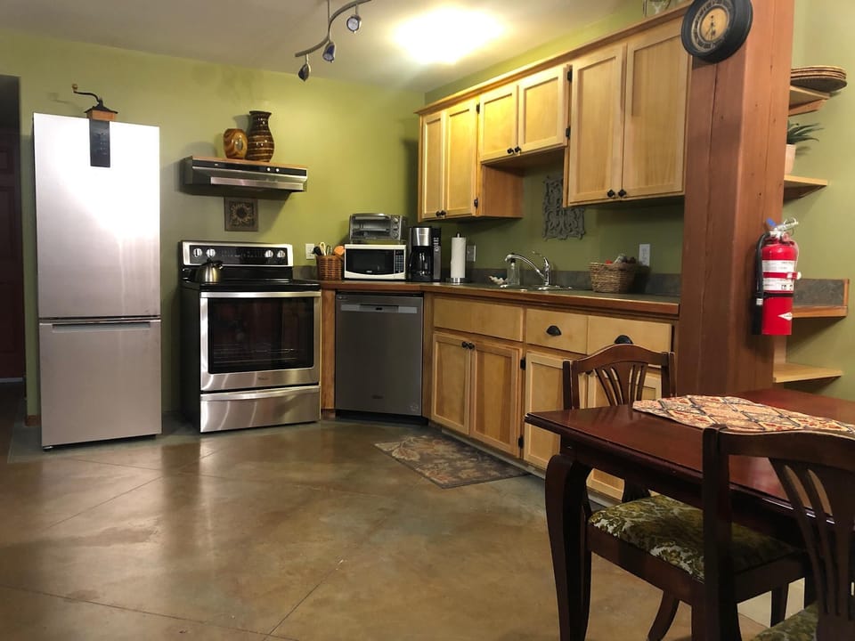The open design of the dining room and kitchen creates a warm and inviting ambiance, perfect for casual family dinners or gatherings with friends. It encourages conversation and makes every meal a delightful experience.