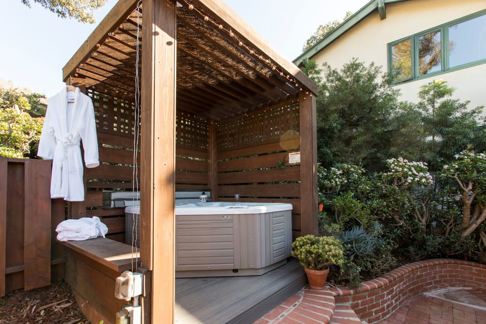 Hot tub with 2 plush white robes waiting for you when you are ready to hop out.