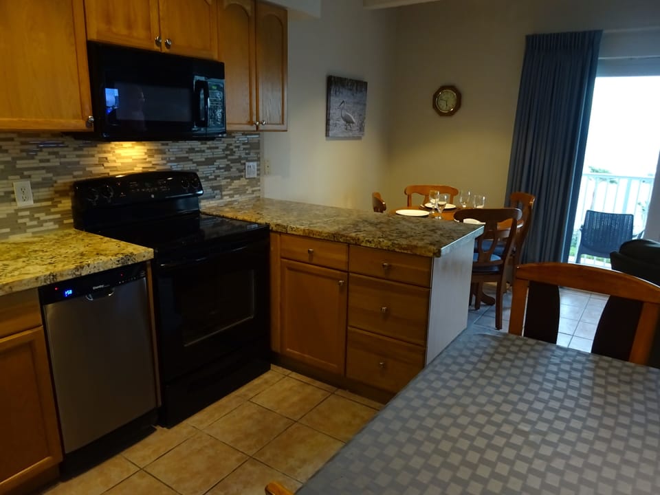 Kitchen/dining and a peek out the patio for the ocean view