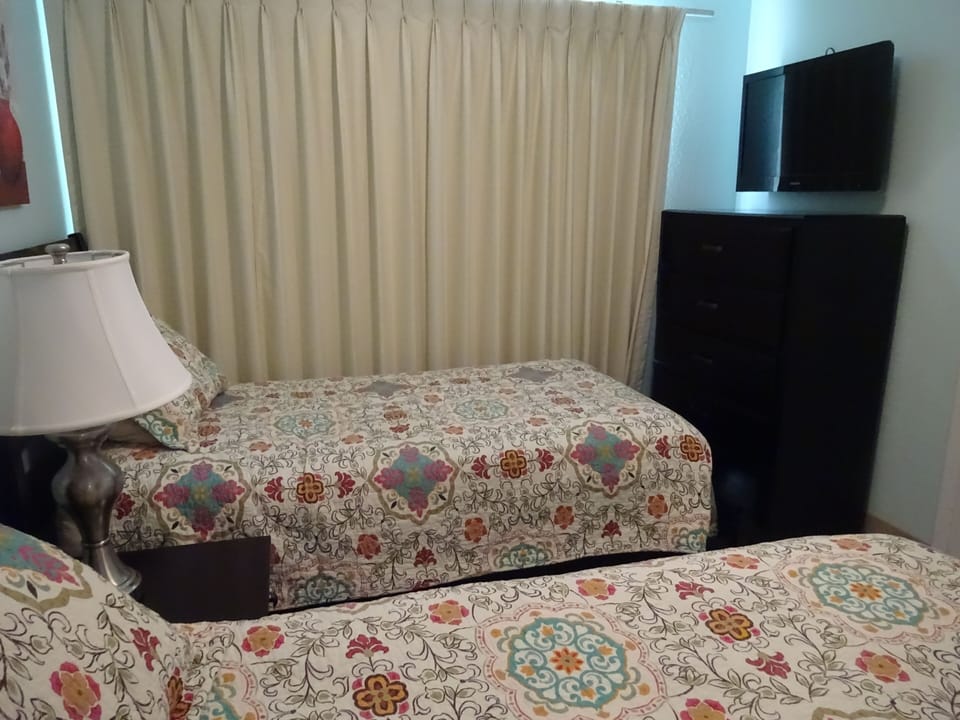 Small bedroom includes a 32" TV & goes out to a patio facing the bridge/bay view