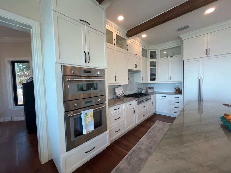 Gourmet kitchen with gas stove, electric over, microwave and wine refrigeration.