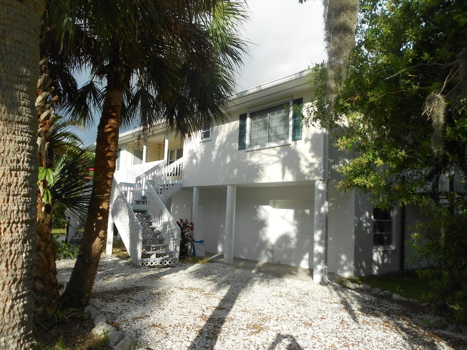Sunlit front balcony 
at NO rEGRETS. Note the guests secure garage.
