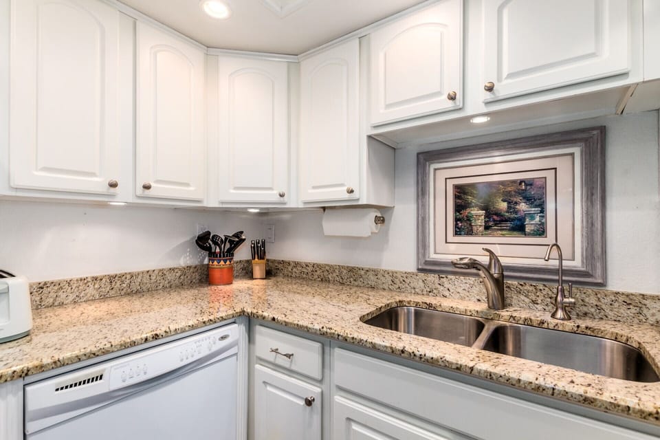 Tons of kitchen cabinets with lots of bright lights